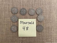Top view of nine Hong Kong one dollar coins arranged around a sticky note with MaxSold 48
