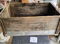 Top and side view of vintage Ocean Spray wooden box showing worn wood grain, older repairs, and nail reinforcements.