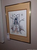 Framed print featuring the Indigenous figure and stylized background.