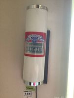 Front view of one Budweiser Light mounted wall lamp showing logo and chrome trim