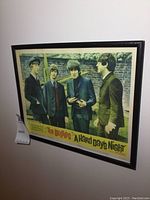 Full view of framed poster angled on wall