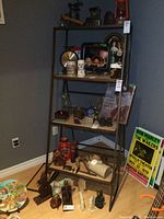 Metal framed display shelf with various items on shelves illustrating size and structure.