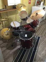 Full kit overview showing red sparkle finish drums, cymbals, stool and sticks