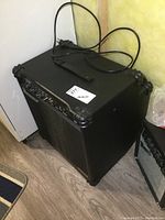 Black Ibanez guitar amplifier angled with attached power cord