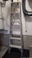 Front and angled view of the 5 ft aluminum step ladder showing five steps, painters shelf, and rubberized feet.