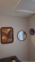 Photo showing all three wall items: copper eagle art, round mirror, Ramones clock.