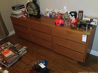 Front-facing view of the full dresser with household items on top