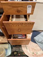 Wooden drawers partially open showing storage items.