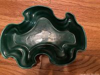 Top view of green free form bowl with wavy edges and organic shape.