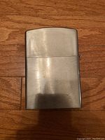 Closed view of the Zippo lighter showing surface wear and tarnish on metal casing