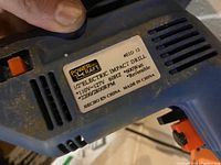 Close-up of label showing Power Craft brand, model EID 12, electrical specifications, and origin.