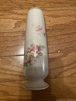 Tall cream-colored vase with hand-painted pink and white flowers