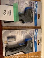 Two unopened Mastercraft digital thermometers in original plastic blister packaging, each with a visible battery included.