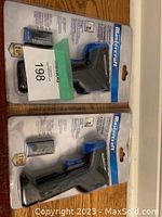 Photo showing two Mastercraft branded digital thermometers in sealed retail packaging with included battery.