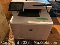 Front and top view of HP Color LaserJet Pro MFP showing touchscreen and paper tray
