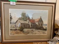 Full-frontal shot of framed painting depicting a rural stone farmhouse.