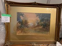 Frontal image of the full painting under glass with mat and decorative gold frame, showing the landscape scene in muted pastel colors.