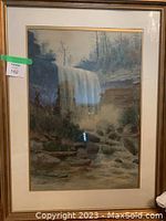 Framed landscape painting under glass featuring a waterfall scene