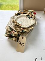 Stacked view of four Fitz and Floyd trays with 3D Christmas-themed ribbon and holly decoration