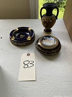 All three items shown together: ashtray, candy dish, and vase on a white surface