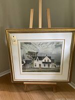Full view of framed AJ Casson print displayed on a wooden easel.