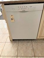 Front view of Bosch dishwasher installed under countertop with visible control panel and closed door.