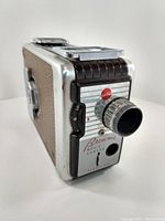 Right angled front view of Kodak Brownie 8mm film movie camera showing lens, focus dial, and front panel with model text.
