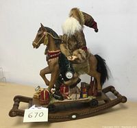 Front and side view showing Santa on the rocking horse with gifts and a pocket watch.