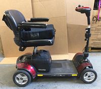 Right side view showing scooter base, seat and front wheel.