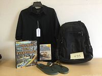 Photo of all items in lot including golf shirt, backpack, flip flops, book and Wii game