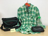Full lot including shirt, Canon camera bag, small black travel bag, and clear plastic water bottle with green lid.