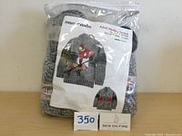 Photo of sealed knitting kit bag showing label with hockey player sweater design and kit details