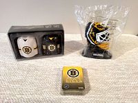 Salt and pepper shakers, mini goalie mask figure in packaging, and playing cards arranged on neutral fabric surface