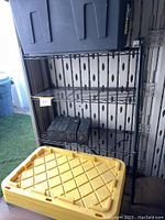 Full view of metal wire rack with storage bins and wood weights on shelves