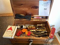 Interior view of carved wooden box showing assorted items