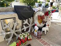 Full view showing all items including snowflakes, snowman, wreath with bow, dog and reindeer figures, wrapped presents, and train on track.