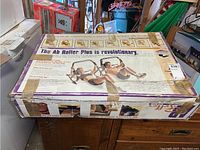 Boxed Ab Roller Plus showing exercise instructions and promotional text on top of box