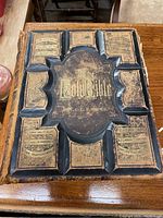 Front cover of the Bible showing embossed leather and gold leaf design with title