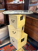 Side view of stacked yellow cube boxes with octagonal mirrored tray on top showing metal handles and latches