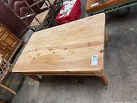 Top view showing rectangular pine wood plank table top and natural wood grain.