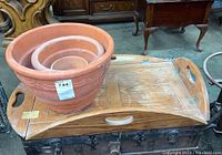 Wood folding tray with three nested terracotta planter pots on top, showing overall condition and size relation.