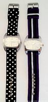 Two vintage Geneva wristwatches side by side with different cloth bands on white background.