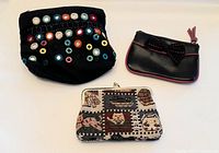 Photo showing all three vintage change purses together on a white background