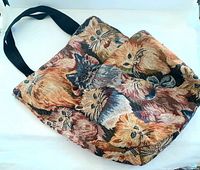Photo showing the entire tote bag with the cat patterned tapestry fabric and black straps.