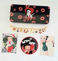 Full lot overhead shot showing bracelet, tin box, and three Betty Boop cards.