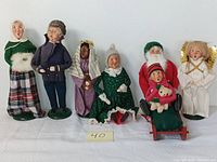 Wide shot of all seven Byers Choice The Carolers figurines in the set, front view.