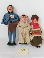 Three Byers Choice Carolers figurines shown side by side on a white background.