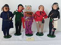 Full frontal photo showing all five Byers Choice Ltd Carolers standing side by side on green bases