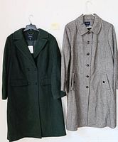 Two Land's End wool coats hanging side by side; one dark green with notch collar and buttons, the other gray with buttons and side pockets.