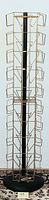 Full view of the tall metal brochure rack with multiple bronze wire compartments attached around a black central pole and black circular base.